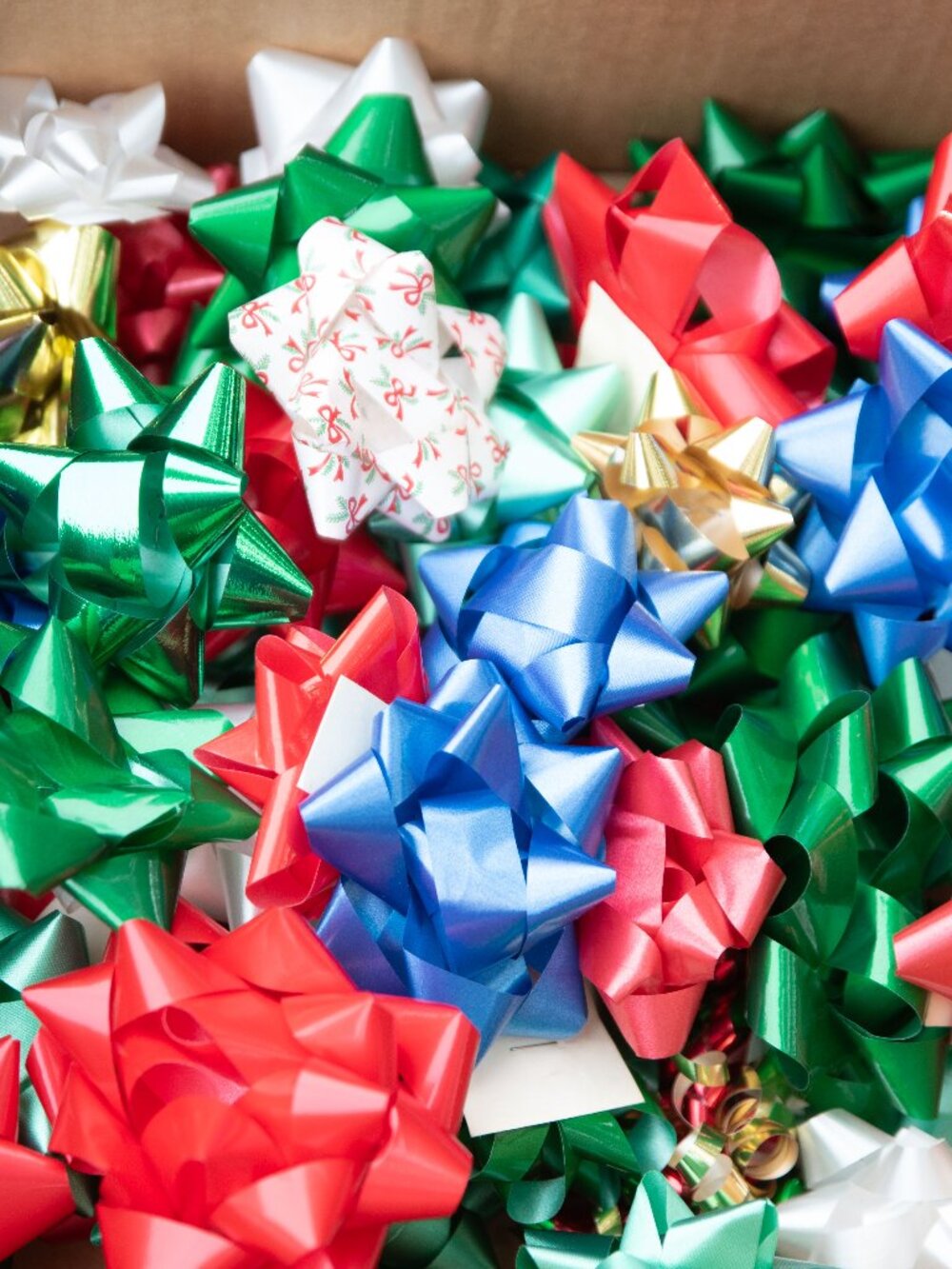 Assortment of colorful, peel-and-stick metallic and patterned holiday gift bows